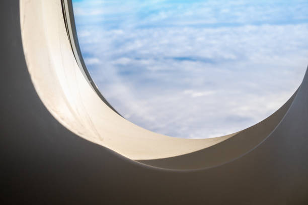 istock Close up airplane window when flying see through at cloud and blue sky,Transportation,Travel concept 876558286