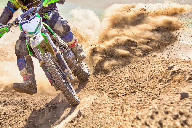 motocross racer accelerating speed in track - motocross leisure activity sport motorcycle racing imagens e fotografias de stock