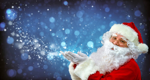 Santa Claus with magic light in his hands Santa Claus with magic light in his hands. Happy Santa Claus blowing  luck photos stock pictures, royalty-free photos & images