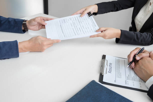 istock Interviewer or Board reading a resume during a job interview, Employer interviewing a young male job seeker for recruitment talking in modern office, employment and recruitment concept 876564874