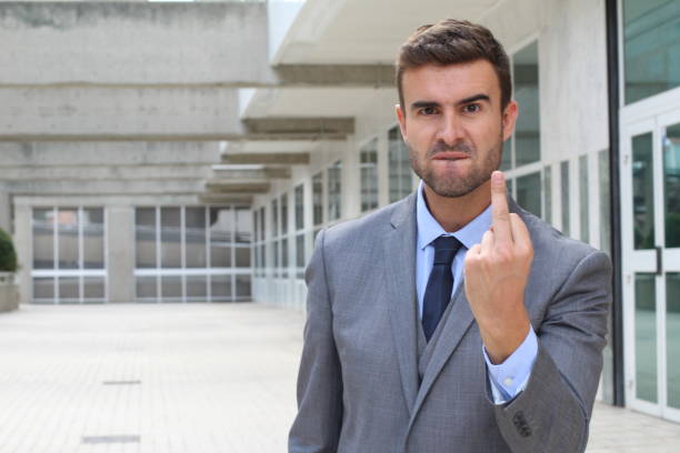 istock Moody businessman showing a middle finger 876569240
