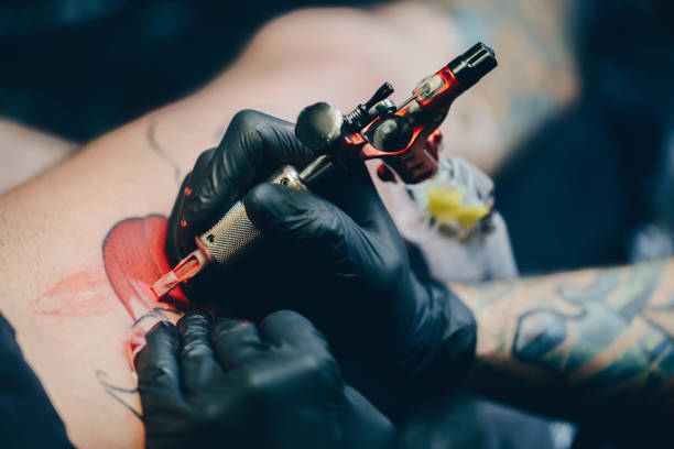 istock Professional artist making tattoo 876569634