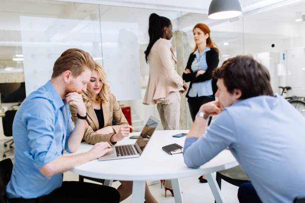 istock Business colleagues sitting at desk 876573532