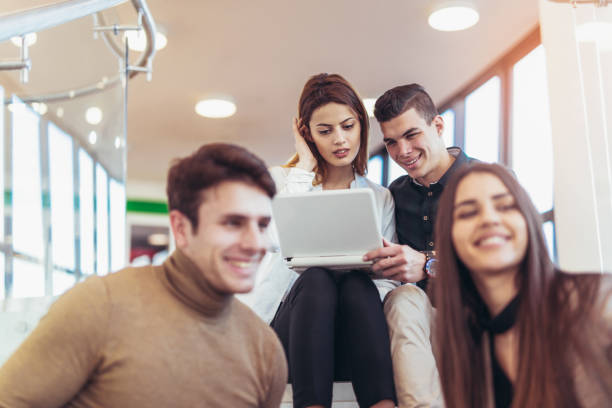 istock Group of students studying on steps of school building 876582410
