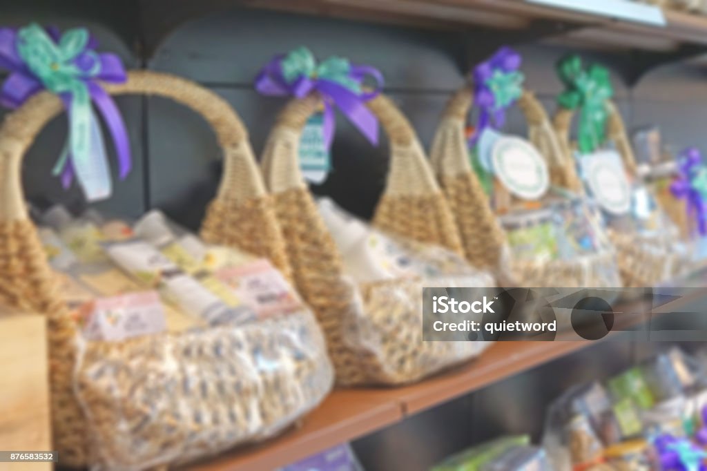 blur photo of wicker basket full with gift pack ready for sale at shelf Basket Stock Photo