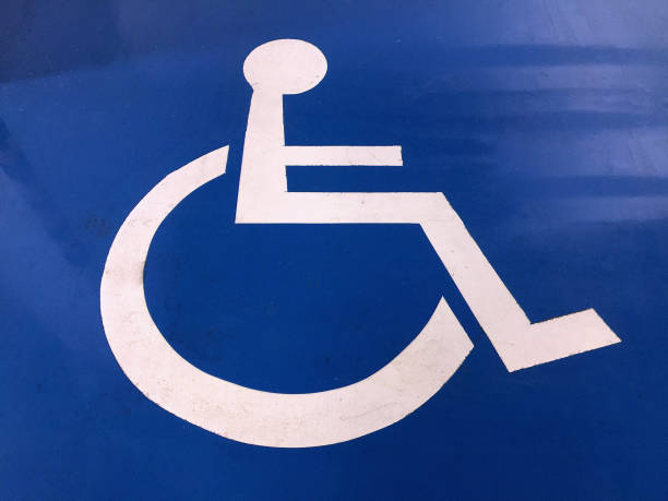istock White Painted Handicap Parking Sign on Blue Floor 876587476