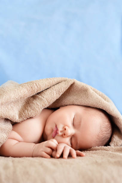 sleeping newborn boy stock photo