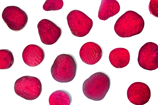 Raw beet root slices isolated on white background