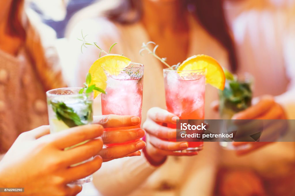 Young men and women drinking cocktail at party Cocktail Stock Photo