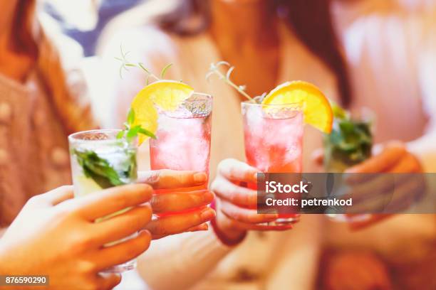 Young Men And Women Drinking Cocktail At Party Stock Photo - Download Image Now - Cocktail, Drinking, Drink