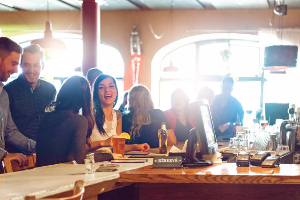 istock Coworkers hanging out in a bar 876595850