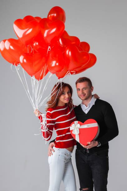 istock Couple with heart shaped balloons 876596812