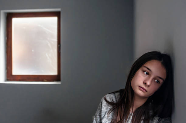 istock Depressed teenager sitting lonely 876597670