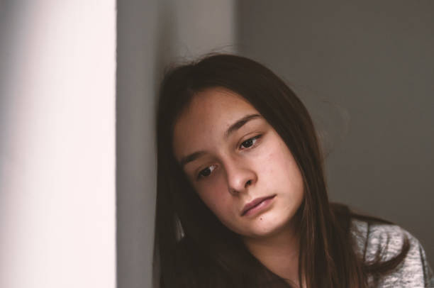 istock Depressed teenager sitting lonely 876597680
