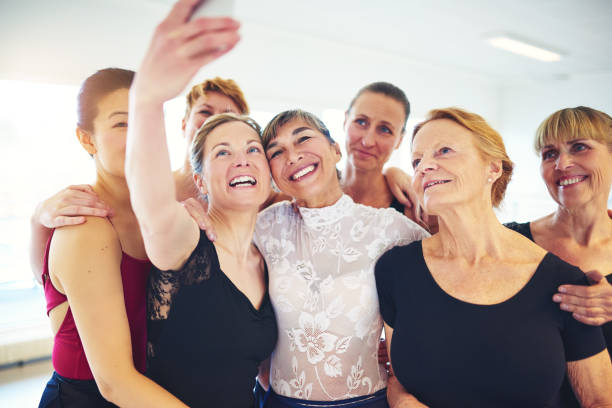 istock Smiling friends taking selfies together in a dance studio 876598468