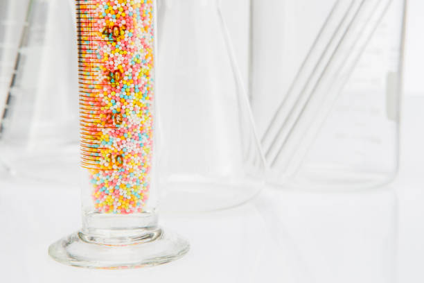 Laboratory sprinkle sugar in glassware for liquids on white background