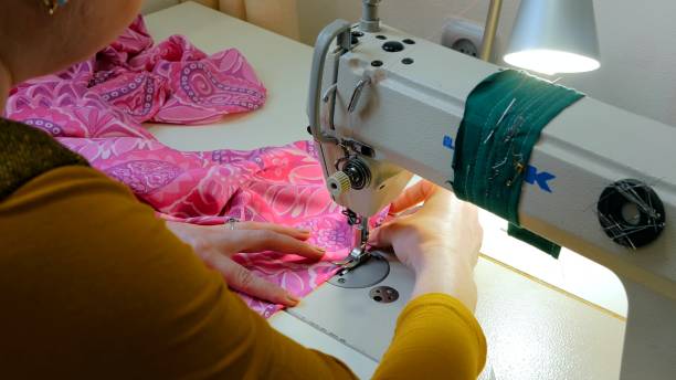 istock Professional tailor, fashion designer sewing clothes with sewing machine 876601356