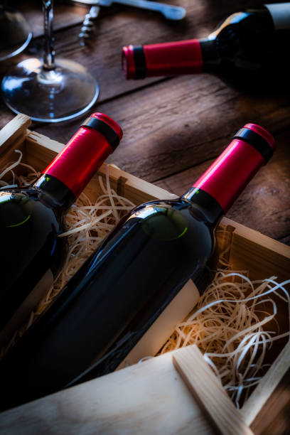 istock Wine bottles packed in a wooden box shot rustic wooden table 876611192