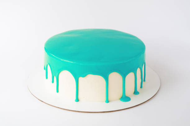 Cake baking with cyan glaze on white background.
