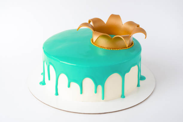 istock Cake baking with cyan glaze decorated with gold crown on white background. 876614758
