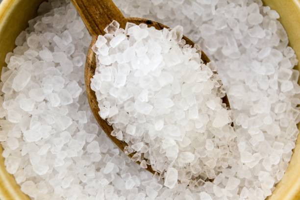 istock Sea salt with a wooden spoon 876625494