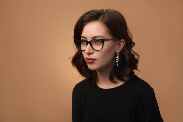 istock Elegant brunette posing in glasses 876629140