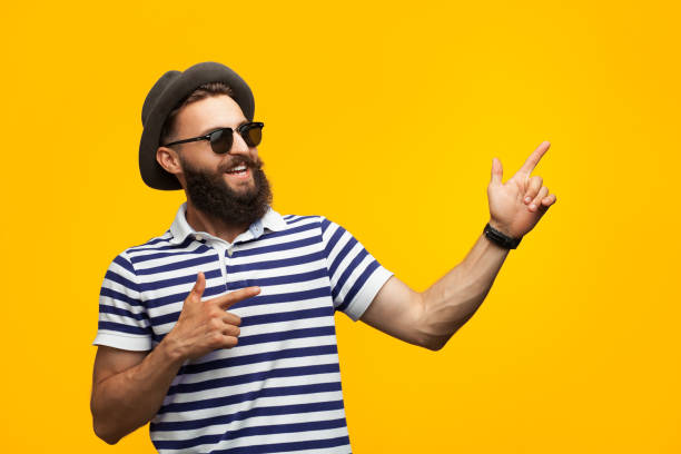 istock Young cheerful man on orange 876629728