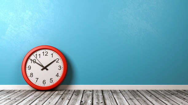 istock Clock on Wooden Floor Against Wall 876635068