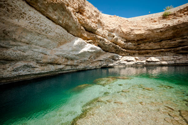 istock bimmah sinkhole, geological depression in the limestone, oman 876638056