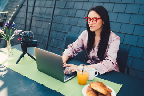istock Attractive woman vlogging at the terrace 876641498