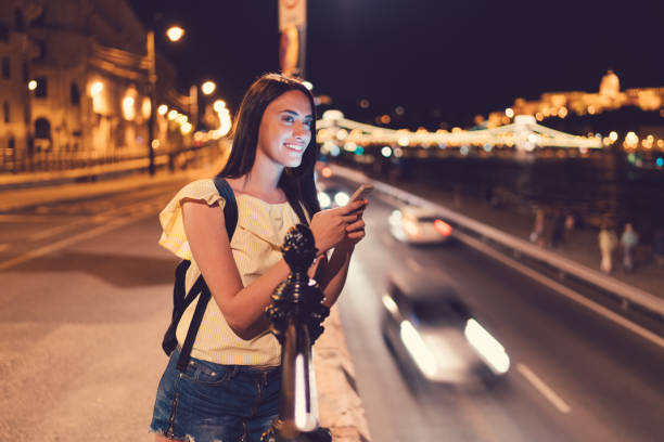 istock Cute girl texting for taxi 876641580