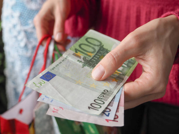 istock Customer pays euro bills cash while shopping. 876645952