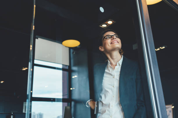 istock Smiling business woman in open space office 876649316