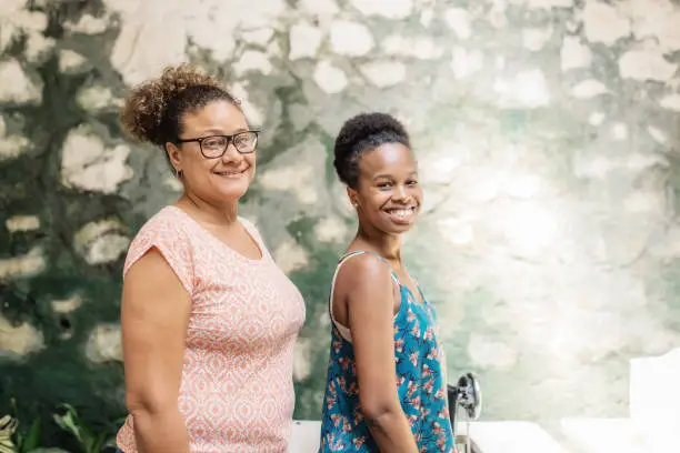 Photo of portrait of two brazilian woman in tailor workroom