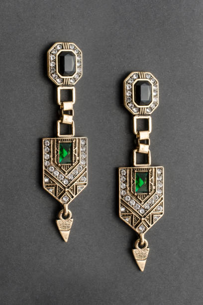 gold ohrringe im stil des art déco isoliert auf schwarz - jugendstil schmuck stock-fotos und bilder