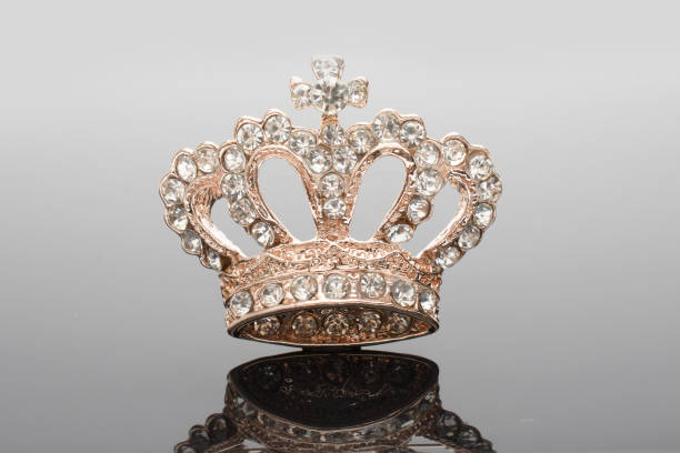 istock golden brooch crown isolated on black 876652050
