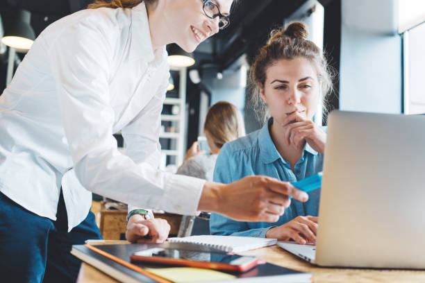 istock Business woman with mobile phone standing in open space office 876653394