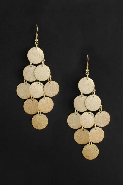istock gold earrings isolated on black 876656264