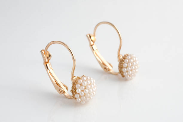 istock golden earrings with pearls isolated on white 876656442