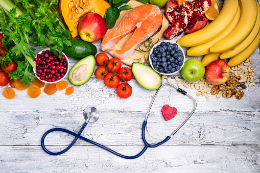 Healthy food for heart. Fresh fish, fruits, vegetables, berries and nuts. Healthy food, diet and healthy heart concept. Top view