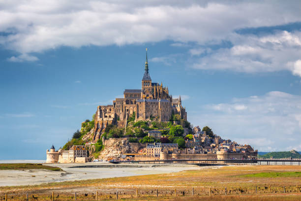 Beautiful panoramic view of famous Le Mont Saint-Michel tidal island with blue sky. Normandy, northern France Beautiful panoramic view of famous Le Mont Saint-Michel tidal island with blue sky. Normandy, northern France marazion photos stock pictures, royalty-free photos & images