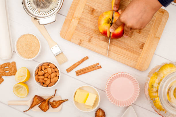 istock Hands Cutting Apple on Wooden Cutboard 876671036