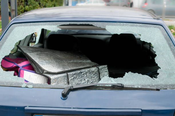 Broken rear windshield glass on damaged car close up selective focus