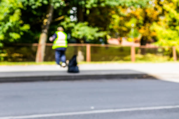 istock Abstract blurred background  - road sweeper worker cleaning city street with broom tool 876671488