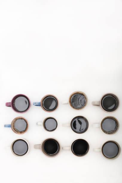 istock Twelve mugs of coffee isolated on white background with copy space 876671760