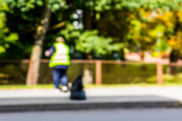 istock Abstract blurred background  - road sweeper worker cleaning city street with broom tool 876672166