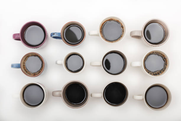istock twelve mugs of coffee isolated on white background top view 876672260