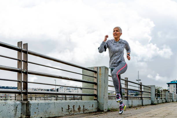 istock Vital senior woman jogging 876679410