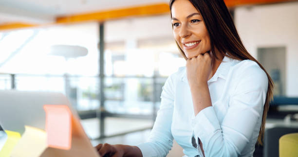 istock Attractive young female architect working on laptop 876679508