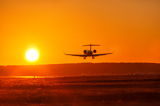 Airplane landing airport sun sunset private jet vacation holidays travel traveling plane aircraft travelling